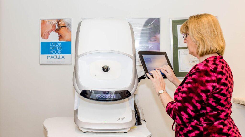 Eavan using Optomap Scanner at Ek Eyewear opticians, Belfast
