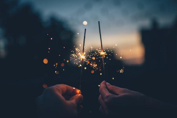Two people holding sparklers and Halloween